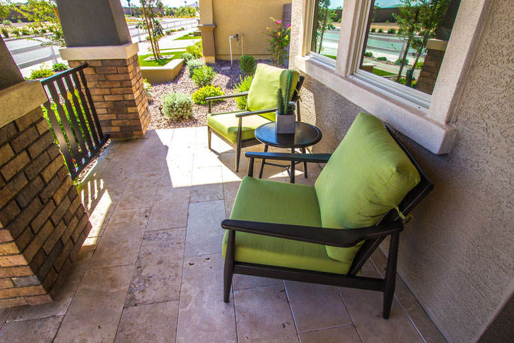 Quiet Front Porch Setting With Small Table And Two Arm Chairs