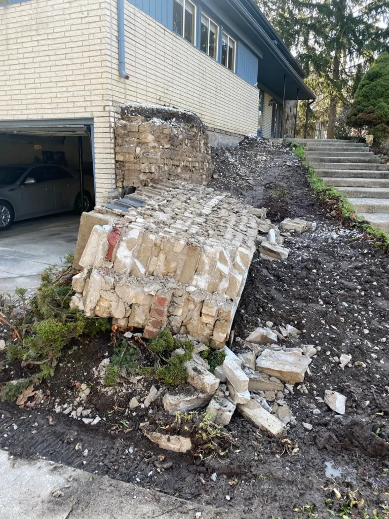Before: block planter wall rebuild by the garage job before work started