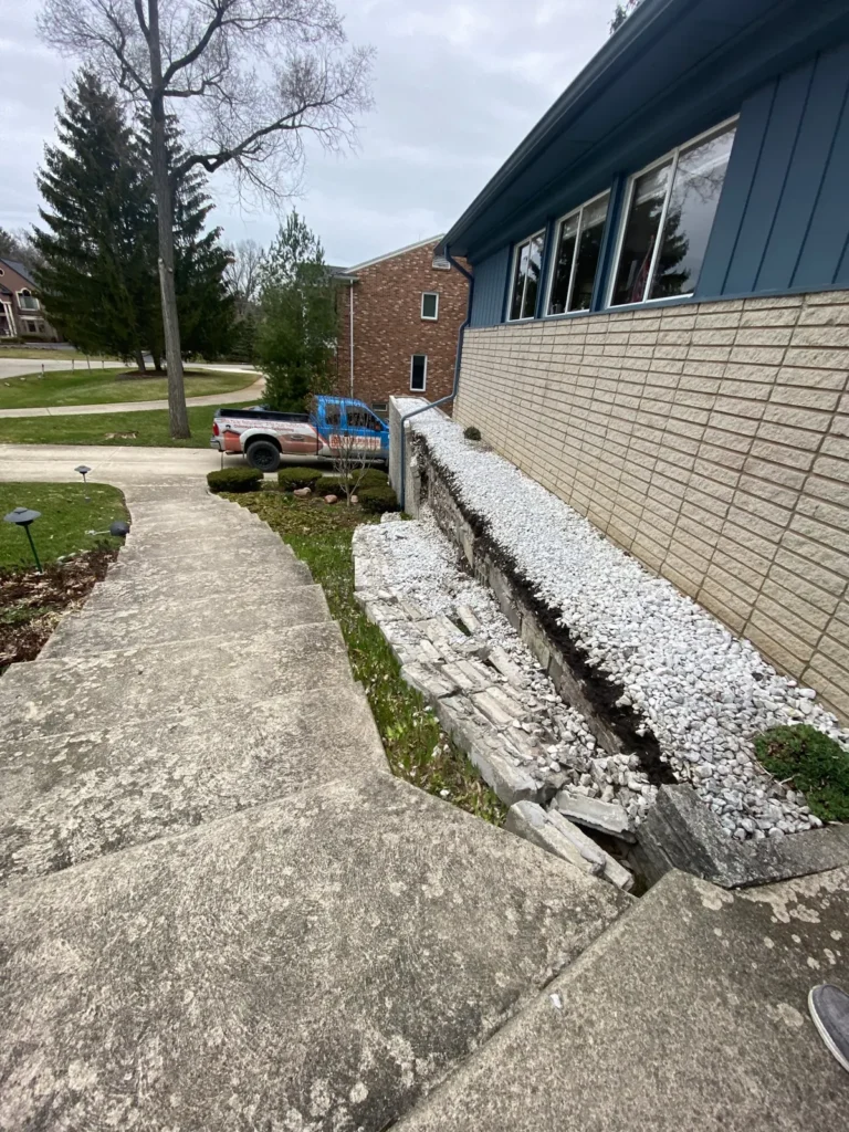 Before: block planter wall rebuild by the garage job before work started