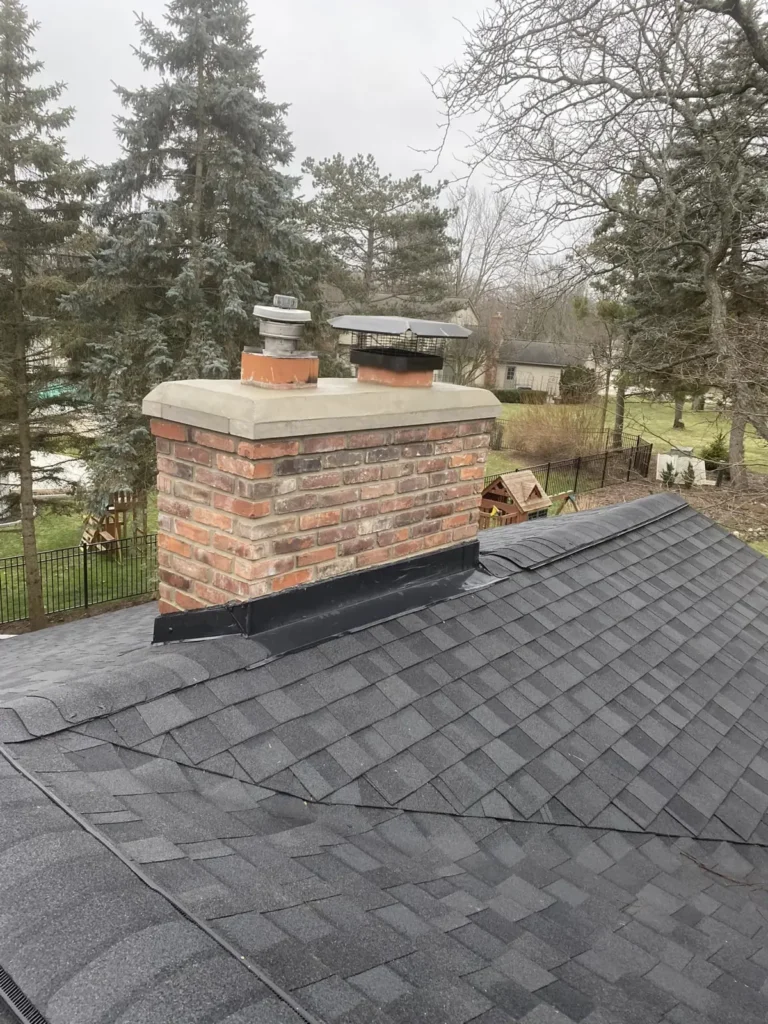 Brick chimney rebuild and new crown, completed by It's The Brick Guys in Metro Detroit (view 2)