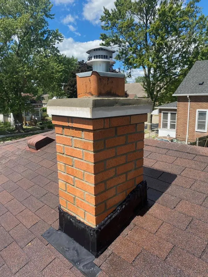Brick chimney rebuild with new cap, completed by It's The Brick Guys in Metro Detroit