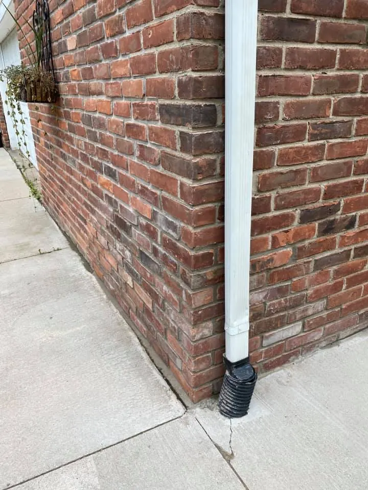 Brick corner repair at the downspout, completed by It's The Brick Guys in Metro Detroit