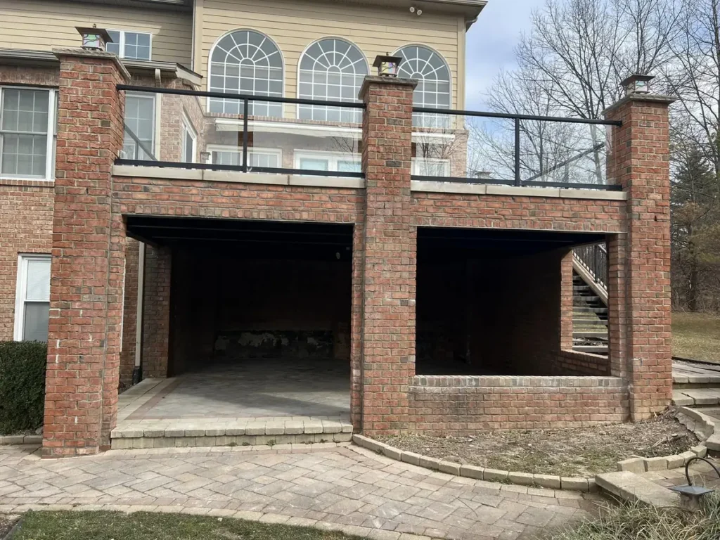 Brick columns and stair walls under a raised deck, rebuilt by It's The Brick Guys