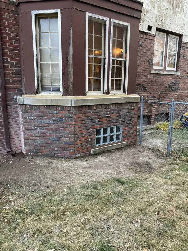 Brick wall rebuilt under a bay window, completed by It's The Brick Guys in Metro Detroit