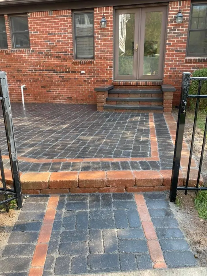 Charcoal brick patio with red border, completed by It's The Brick Guys in Metro Detroit