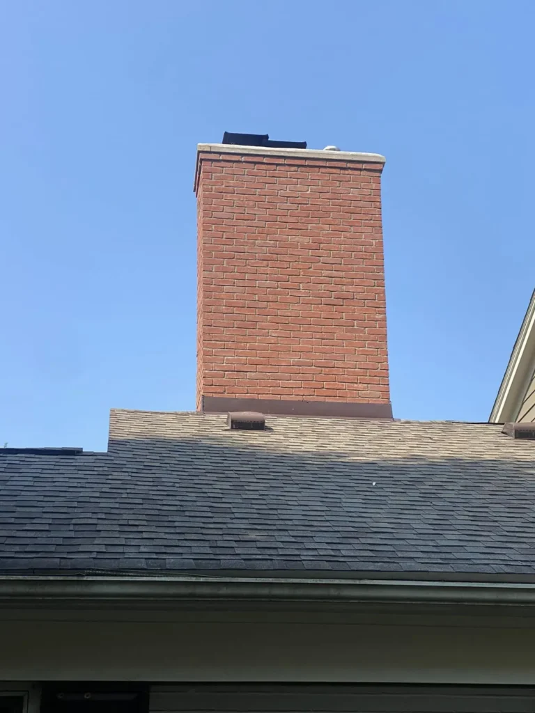 Chimney rebuilt above the roofline, completed by It's The Brick Guys in Metro Detroit