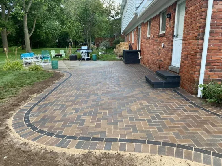 Curved brick paver patio from lawn, completed by It's The Brick Guys in Metro Detroit