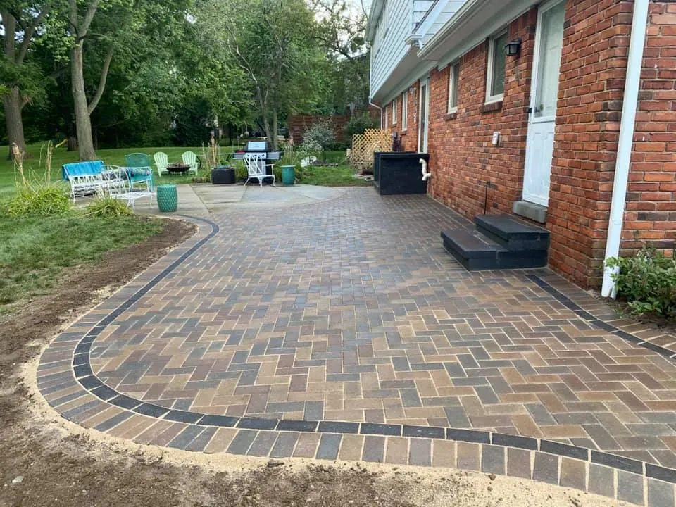Curved brick paver patio from lawn, completed by It's The Brick Guys in Metro Detroit