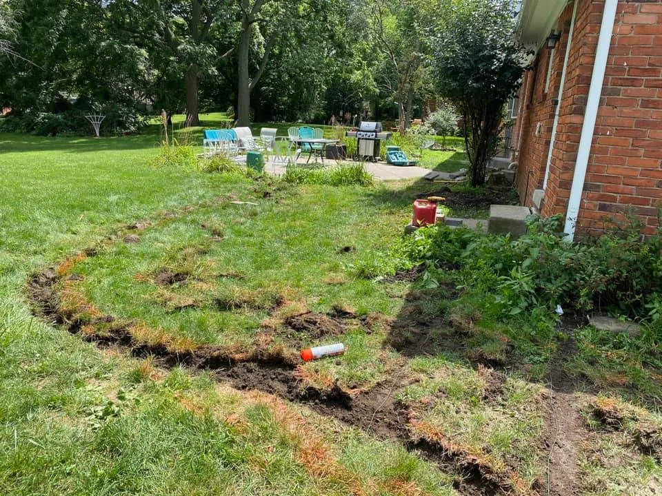 Before: curved brick paver patio from lawn job before work started