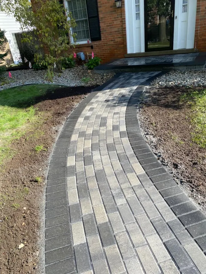 Curved gray paver front walkway, completed by It's The Brick Guys in Metro Detroit