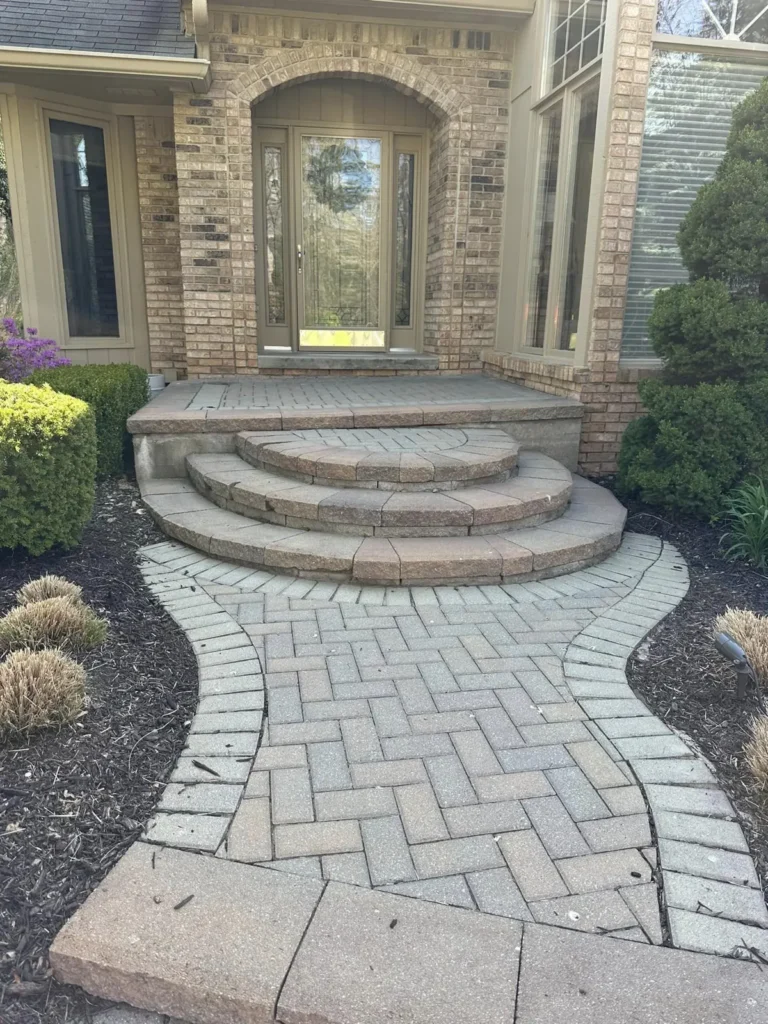 Before: curved red paver front walkway job before work started