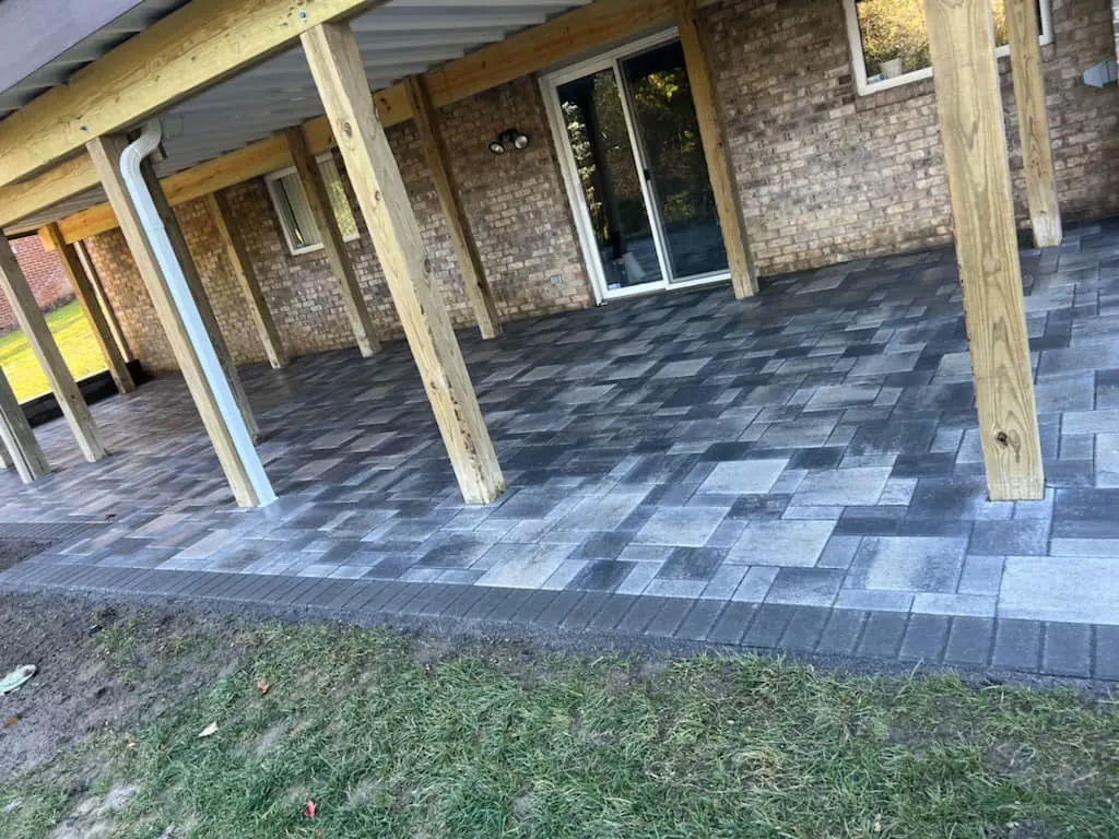 Fendt gray paver patio under a deck, completed by It's The Brick Guys in Metro Detroit
