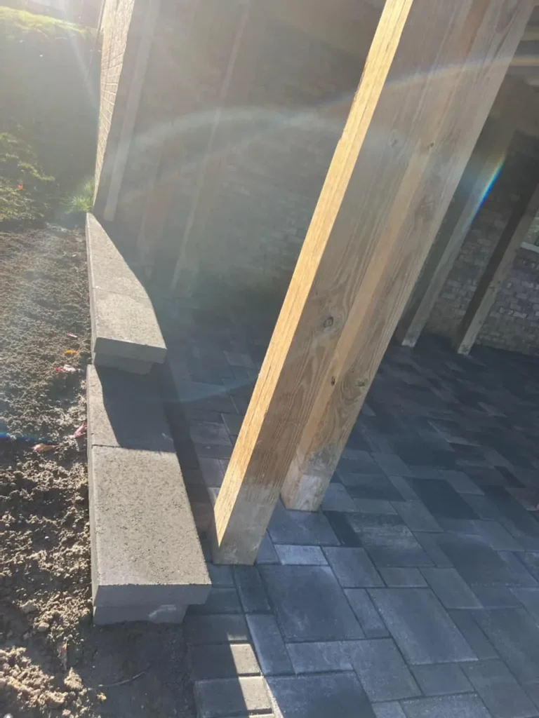 Fendt gray paver patio under a deck, completed by It's The Brick Guys in Metro Detroit (view 6)