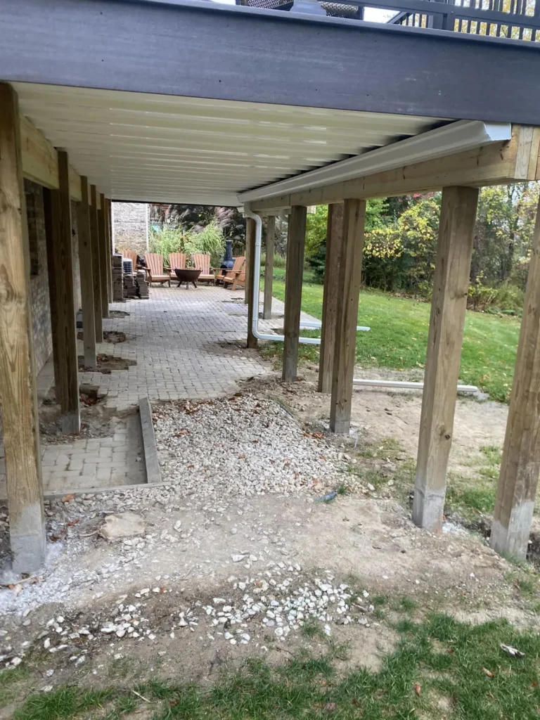 Before: fendt gray paver patio under a deck job before work started