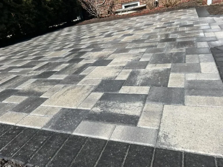 Gray paver patio on a bare lawn, completed by It's The Brick Guys in Metro Detroit
