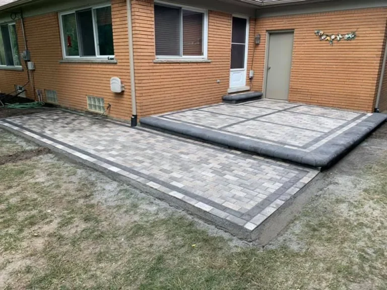 Gray paver patio replacing a garden bed, completed by It's The Brick Guys in Metro Detroit