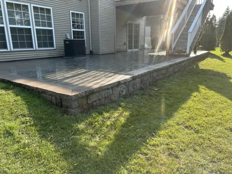 Restored gray paver patio, cleaned and re-sanded, beside a home in Metro Detroit