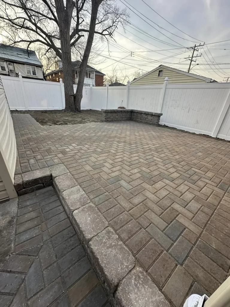 Herringbone paver patio with seat wall, completed by It's The Brick Guys in Detroit, MI (view 2)