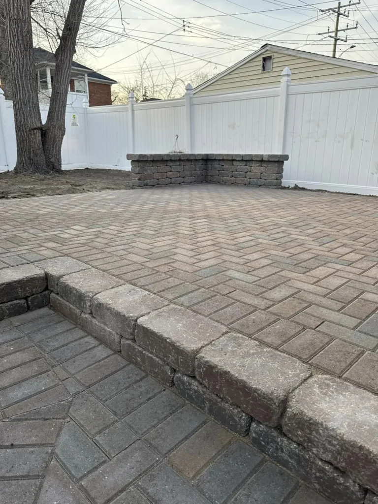 Herringbone paver patio with seat wall, completed by It's The Brick Guys in Detroit, MI (view 3)