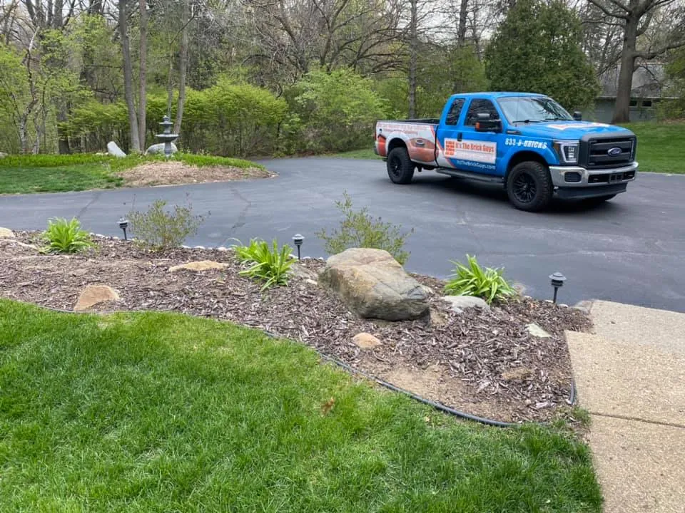 It's The Brick Guys branded truck at a residential job site