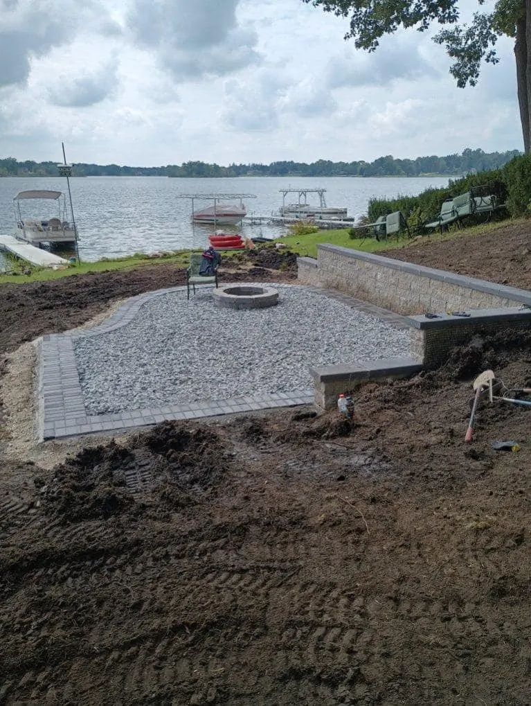 Lakefront patio with fire pit, completed by It's The Brick Guys in Metro Detroit