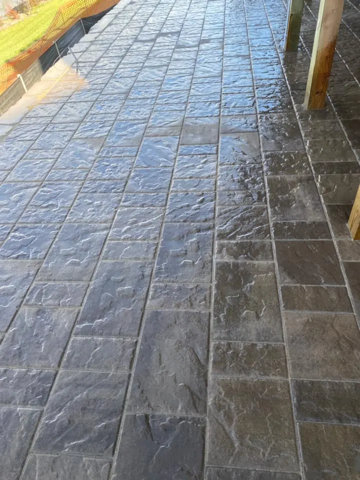 Lakefront paver patio under a deck, completed by It's The Brick Guys in Metro Detroit