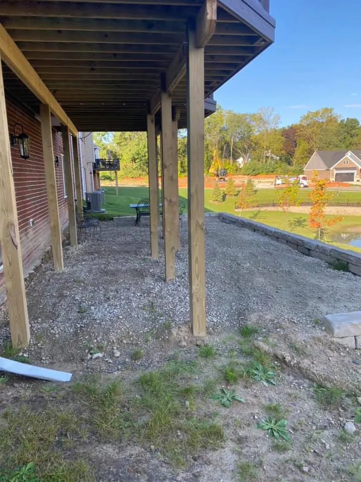 Before: lakefront paver patio under a deck job before work started