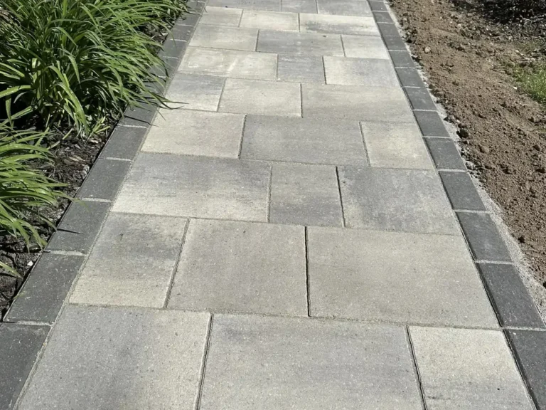 Light gray large-format paver walkway with charcoal border leading to a front door in Rochester, MI