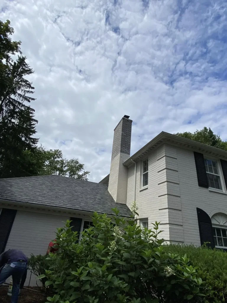 Painted chimney rebuilt in gray brick, completed by It's The Brick Guys in Shelby Township, MI
