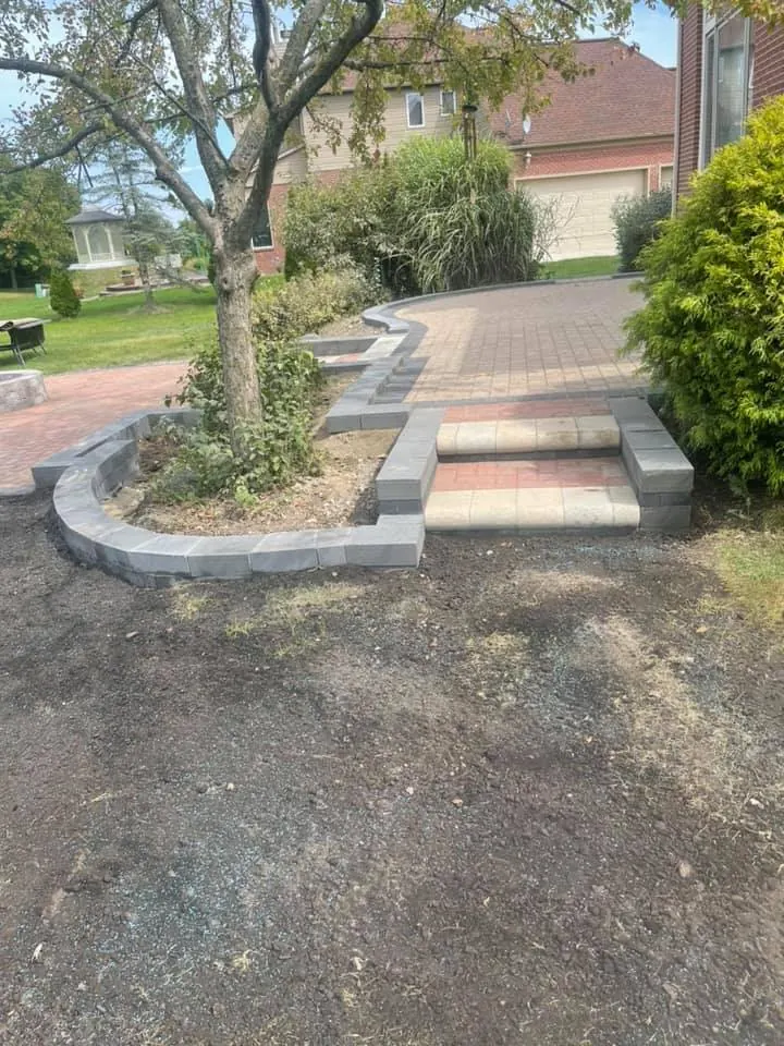 Paver patio with round fire pit, completed by It's The Brick Guys in Metro Detroit
