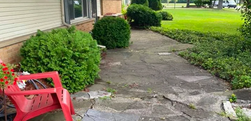 Broken flagstone walkway before replacement