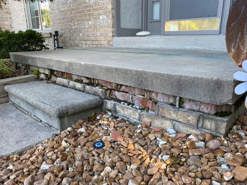 Before: porch base brick repair job before work started
