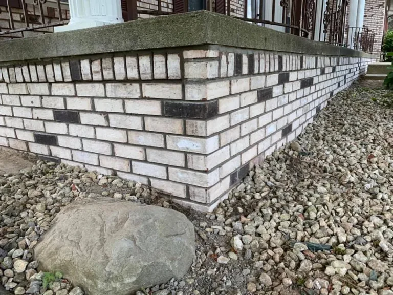 Porch wall rebuilt in white brick, completed by It's The Brick Guys in Metro Detroit