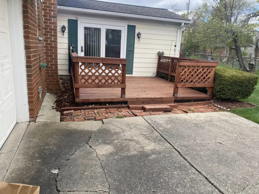 Before: red brick patio replacing a deck job before work started