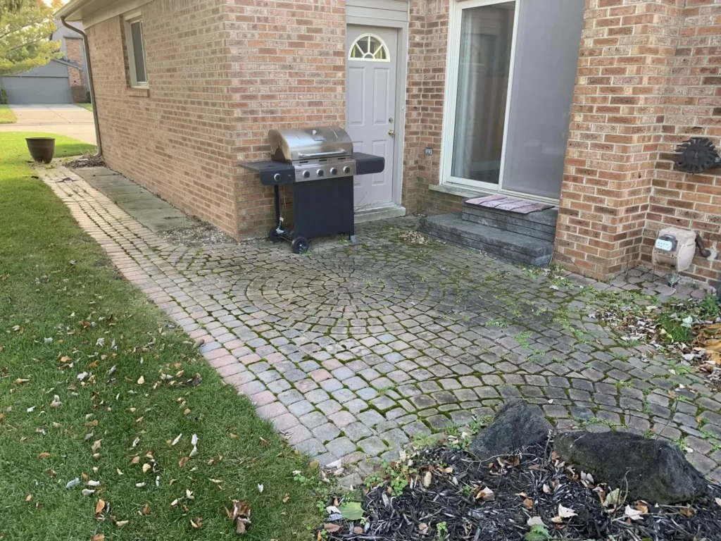 Before: red brick patio with circle pattern and walkway job before work started
