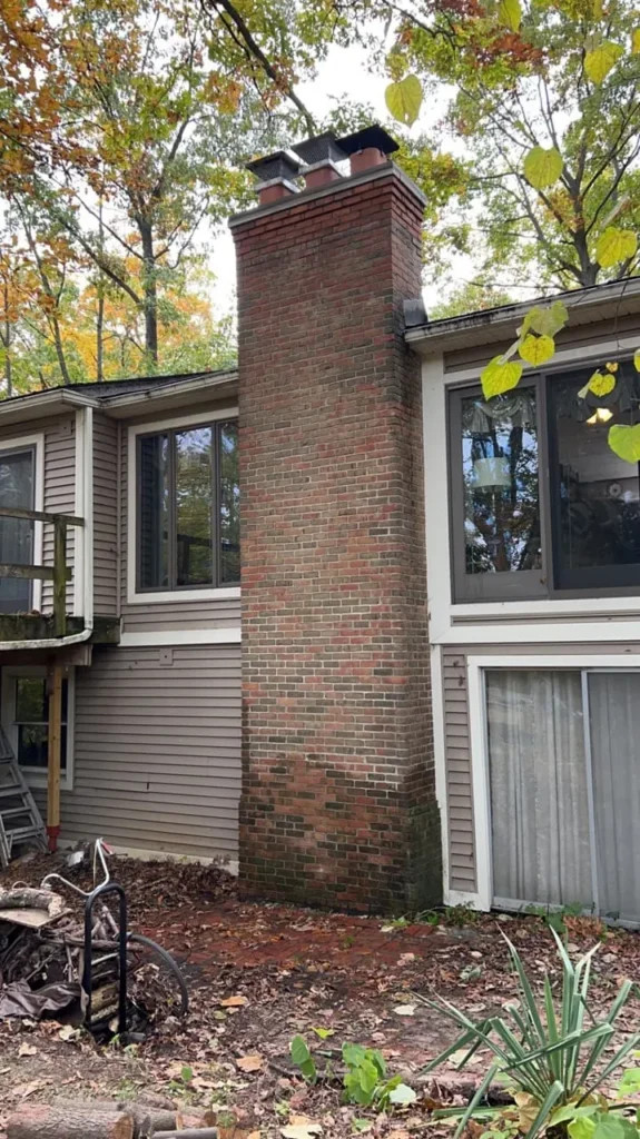 Tall exterior chimney rebuild, completed by It's The Brick Guys in Metro Detroit