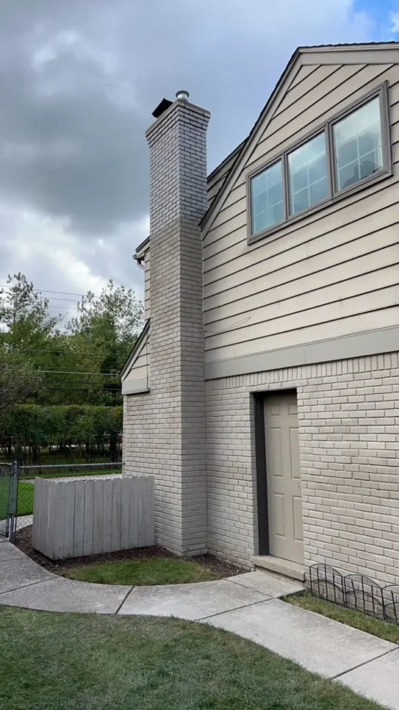 Tall exterior chimney rebuild, completed by It's The Brick Guys in Metro Detroit (view 2)