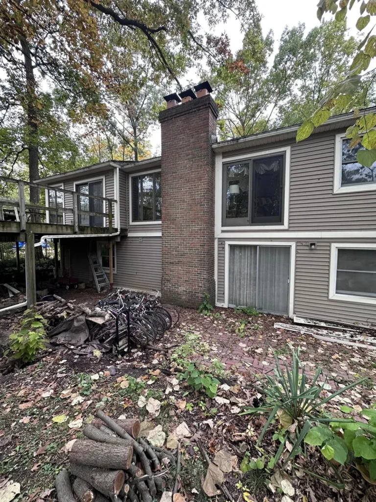 Before: tall exterior chimney rebuild job before work started