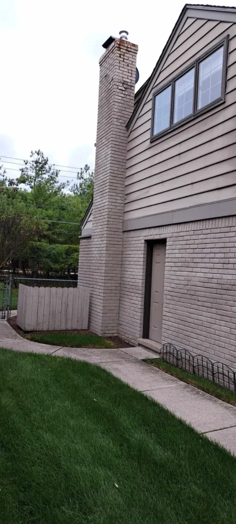 Before: tall exterior chimney rebuild job before work started