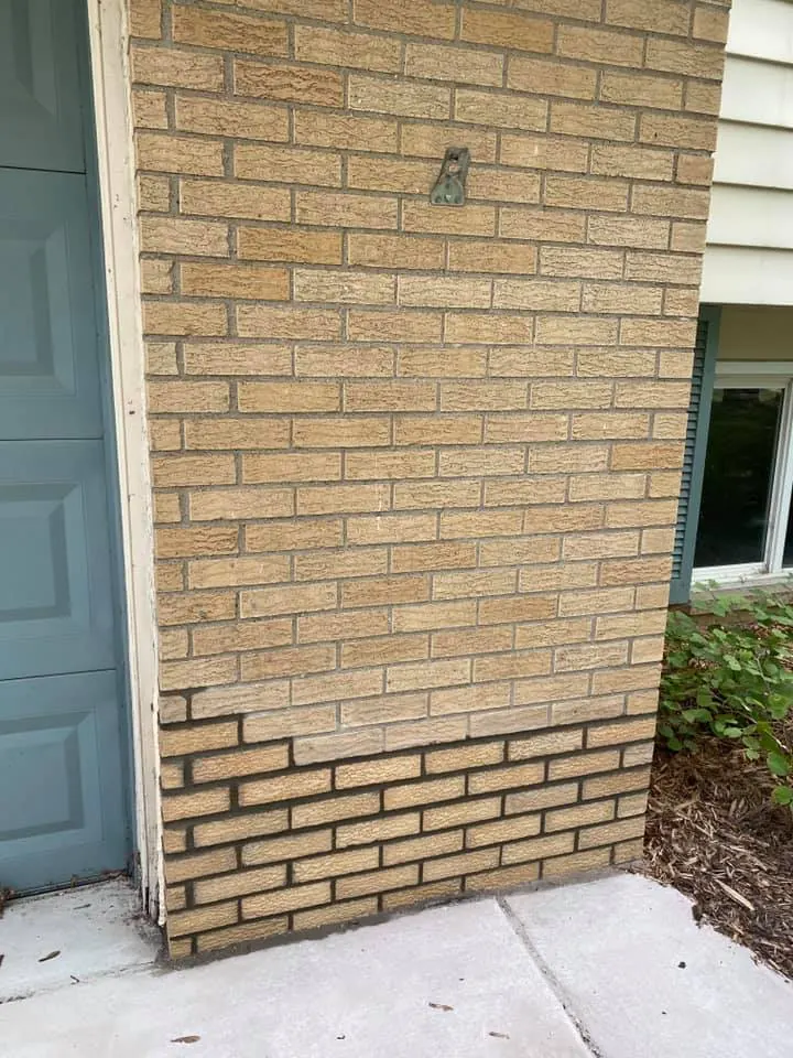 Before: yellow brick wall repair job before work started
